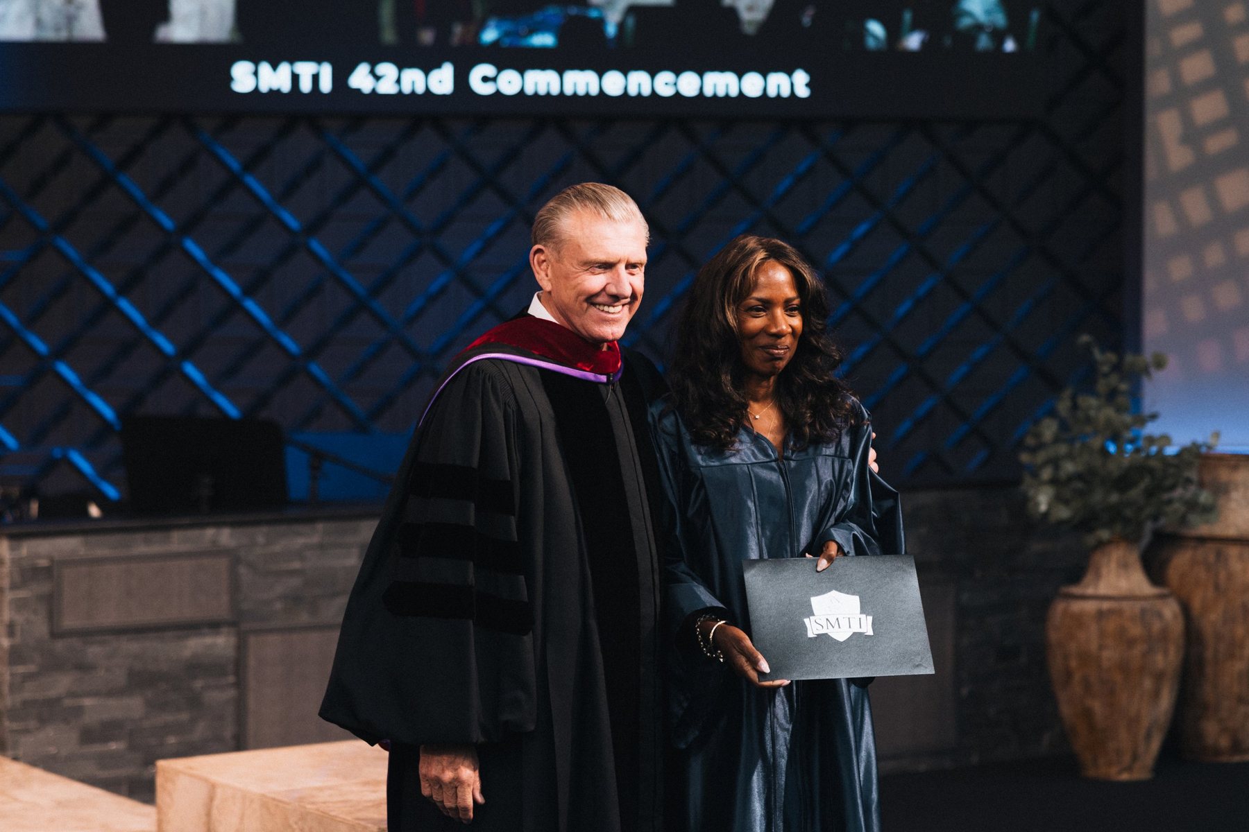 Dr. Mark T. Barclay with a graduate at the 42nd Commencement